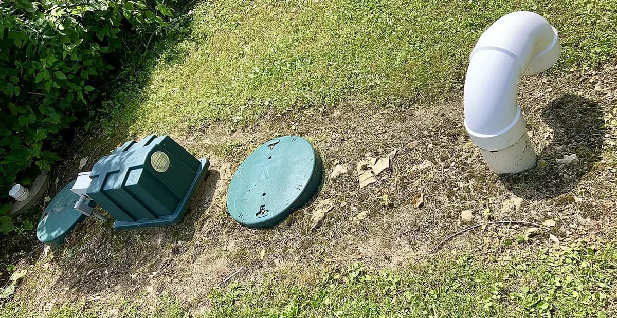 Residential septic tank riser covers and vent pipe ready for septic pumping in San Luis Obispo County